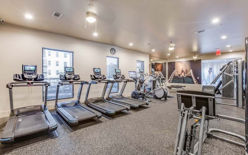 Large fitness center with large windows and plenty of equipment